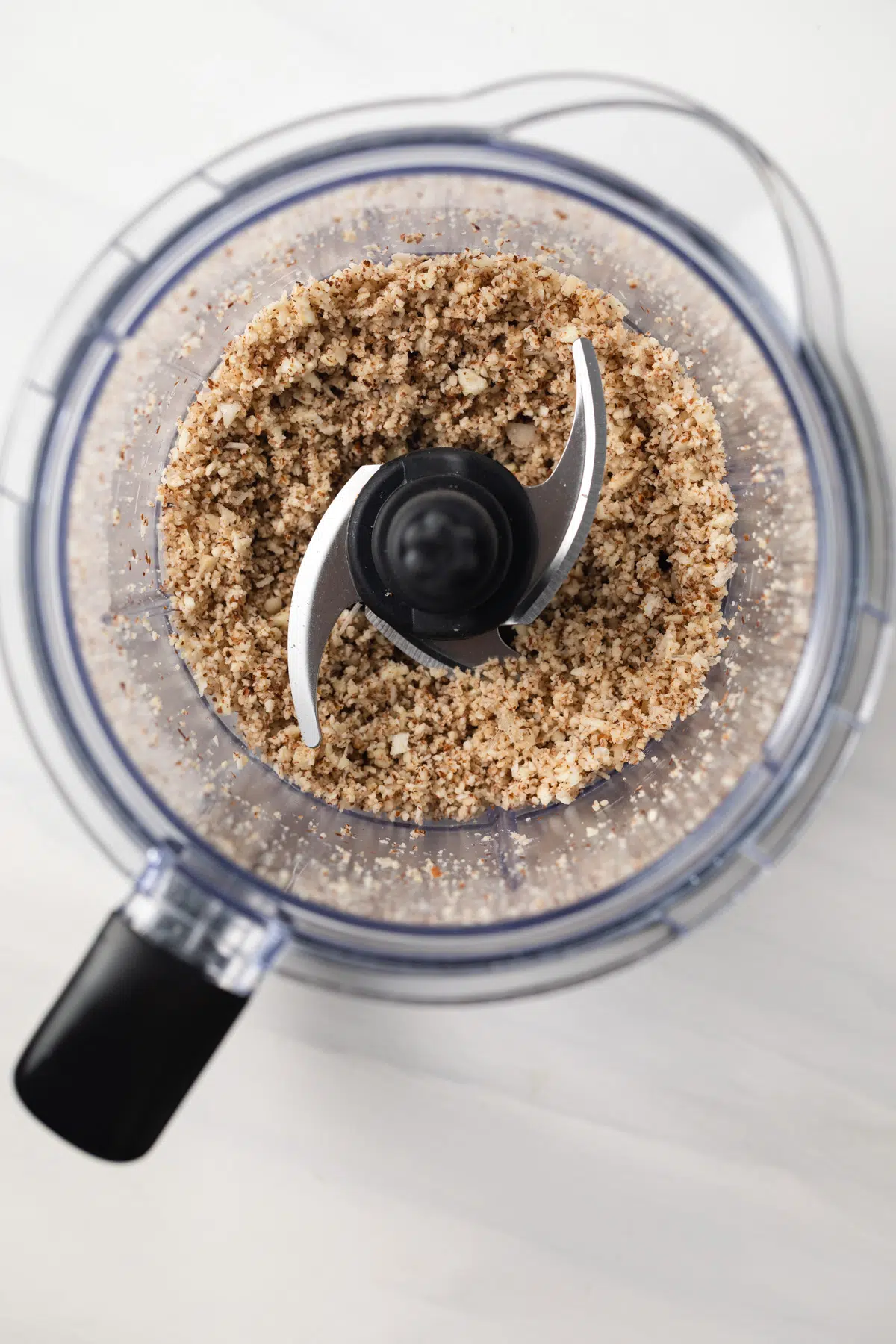 Chopped almonds in a food processor.