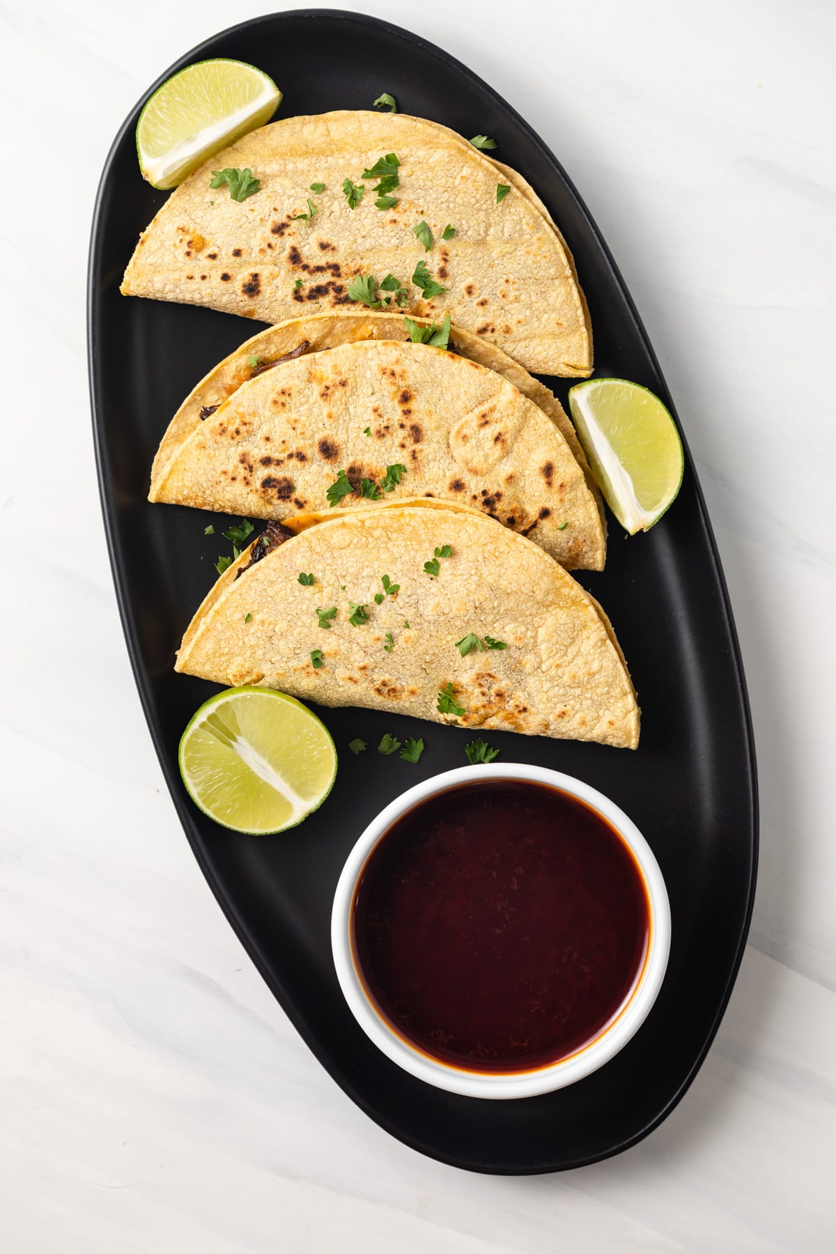 Overhead of birria consume and taco.