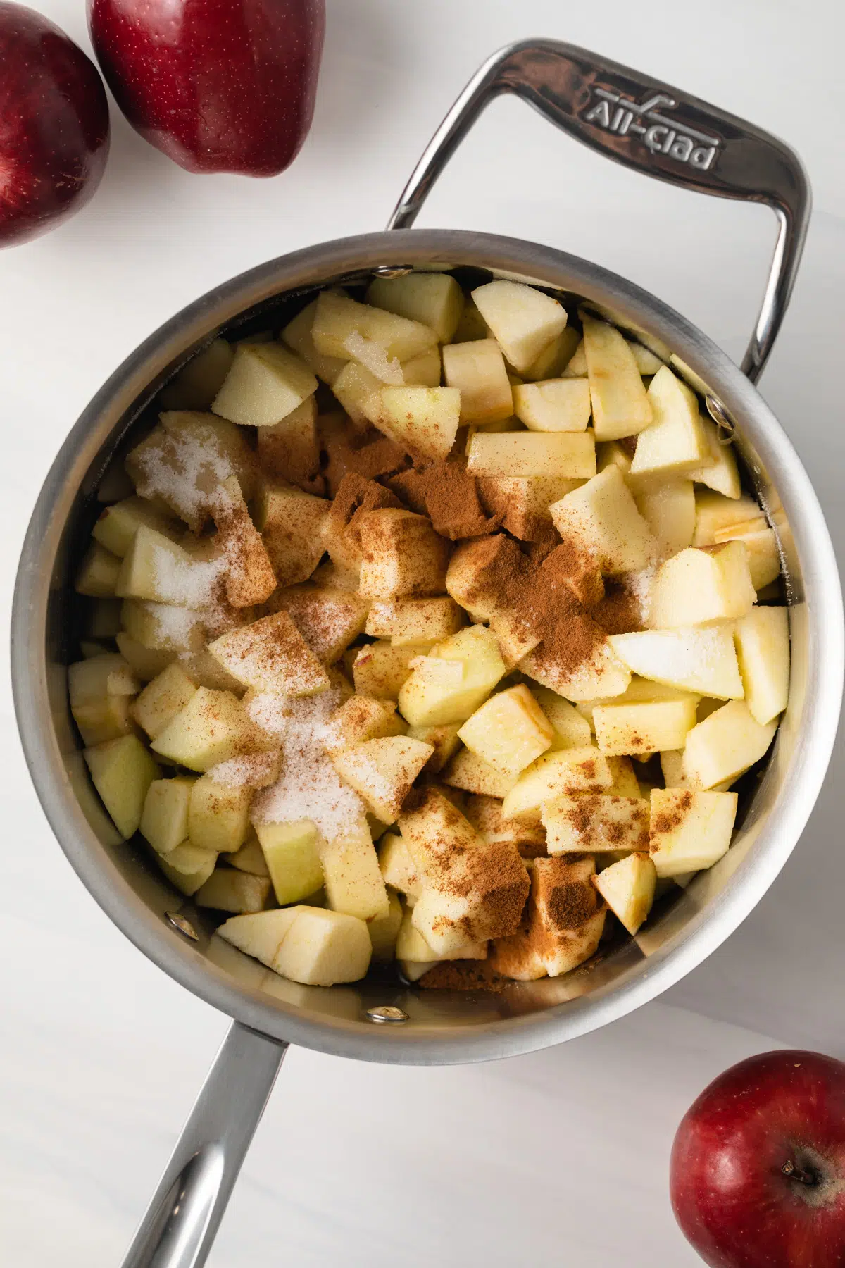 Diced apples with spices in saucepan.
