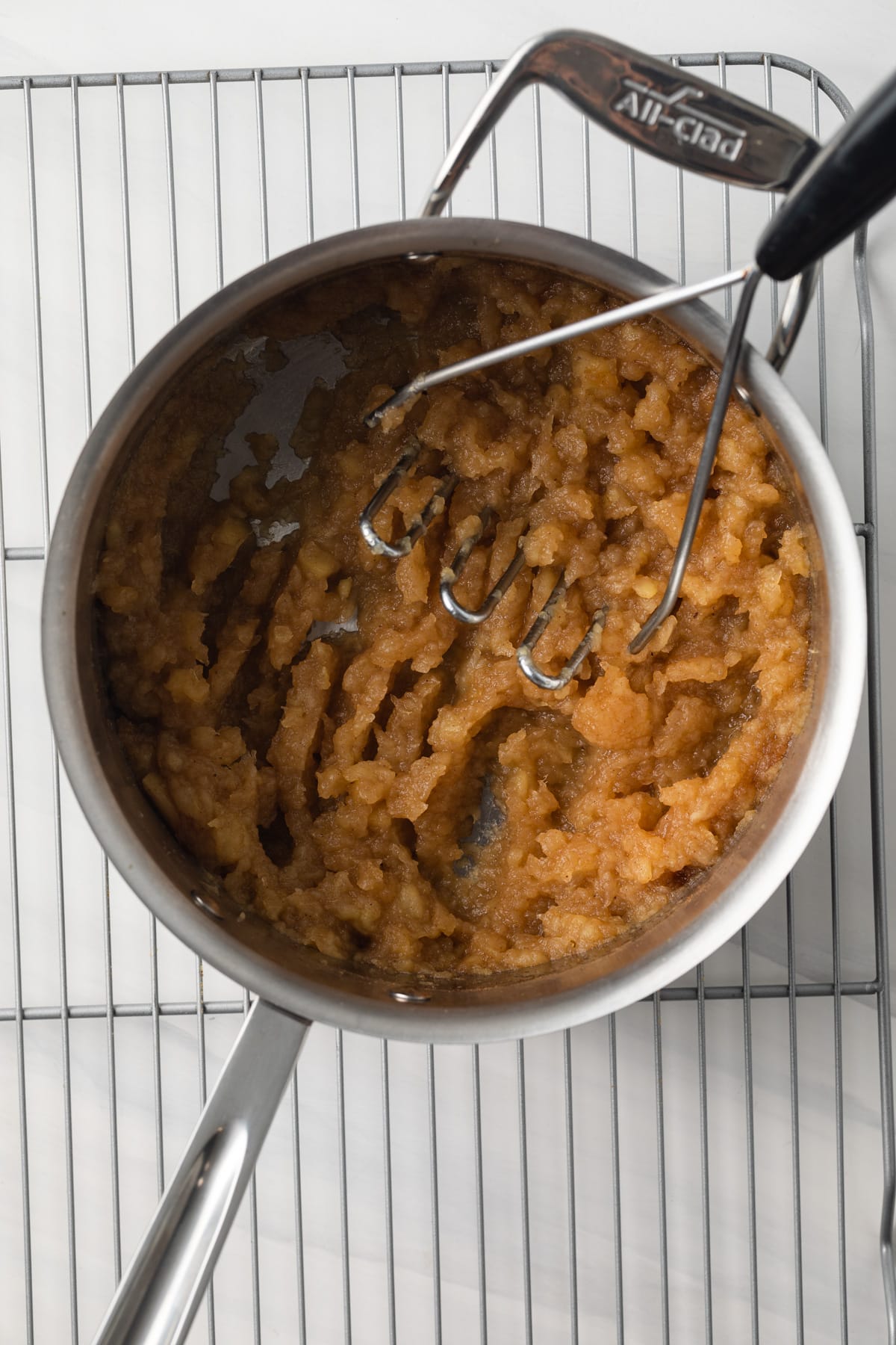 Mashed apples in saucepan.