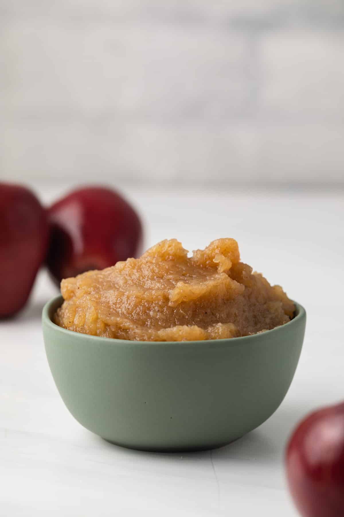 Side view of easy applesauce in green bowl.
