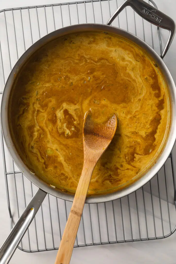 Easy curry sauce with coconut milk in skillet.