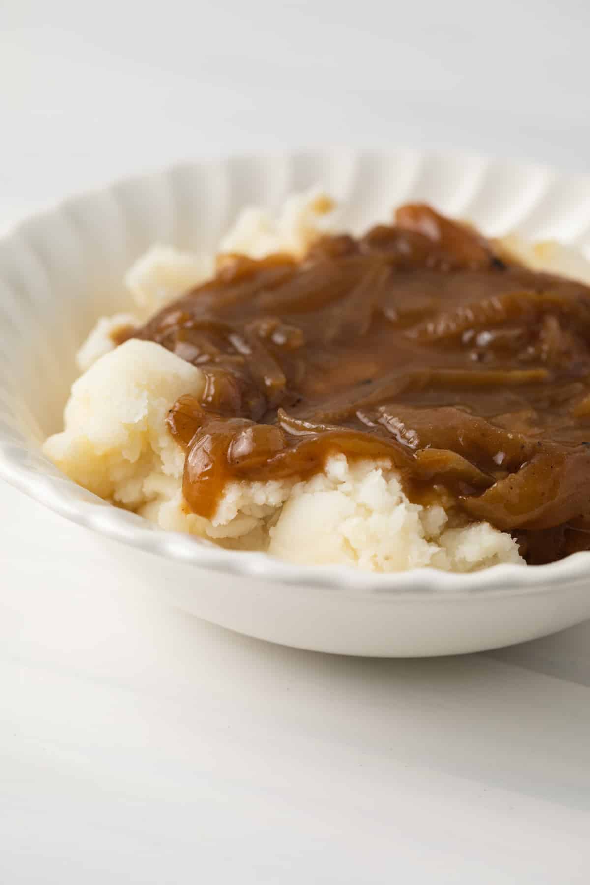 Mashed potatoes topped with onion gravy.
