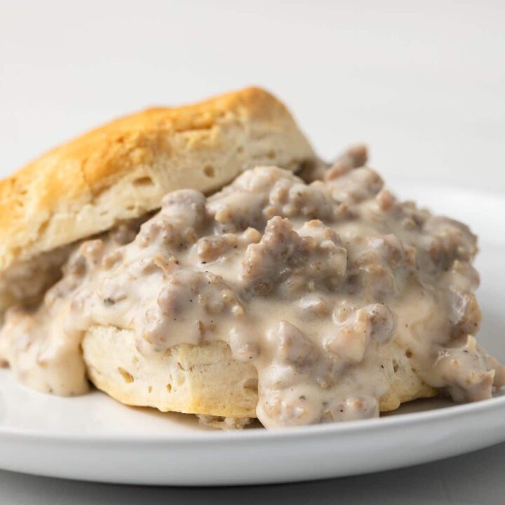 Side view of sausage gravy on a biscuit.