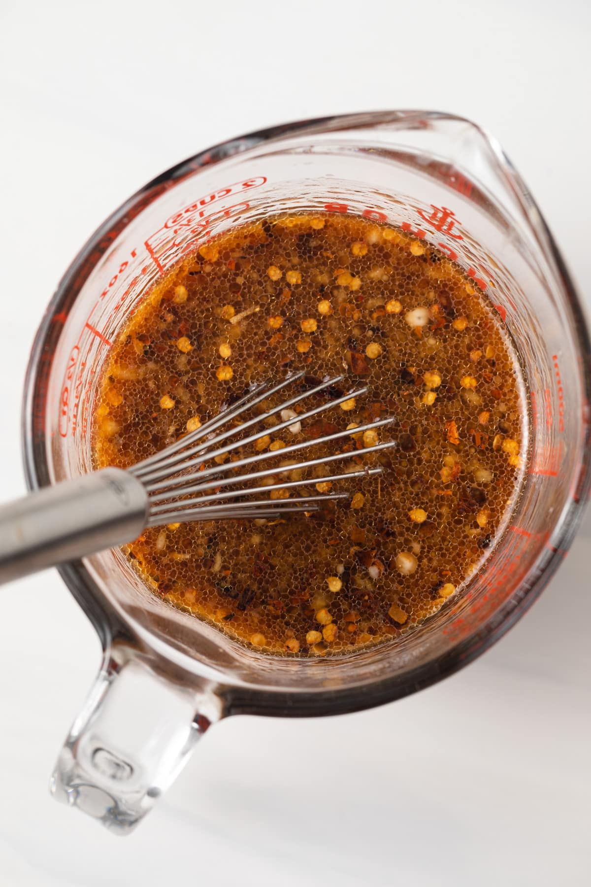 Stir fry sauce in a measuring cup with whisk.