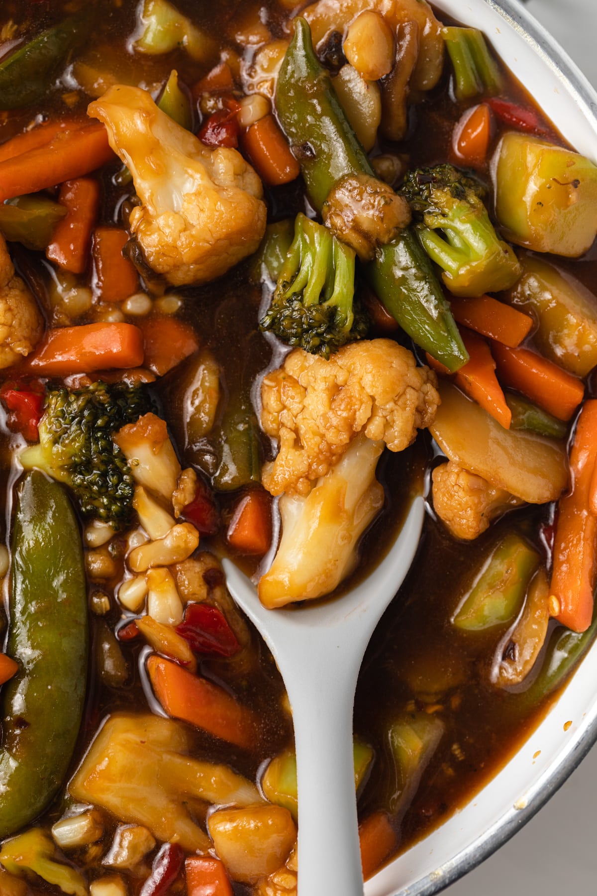 Close up of vegetables in stir fry sauce.
