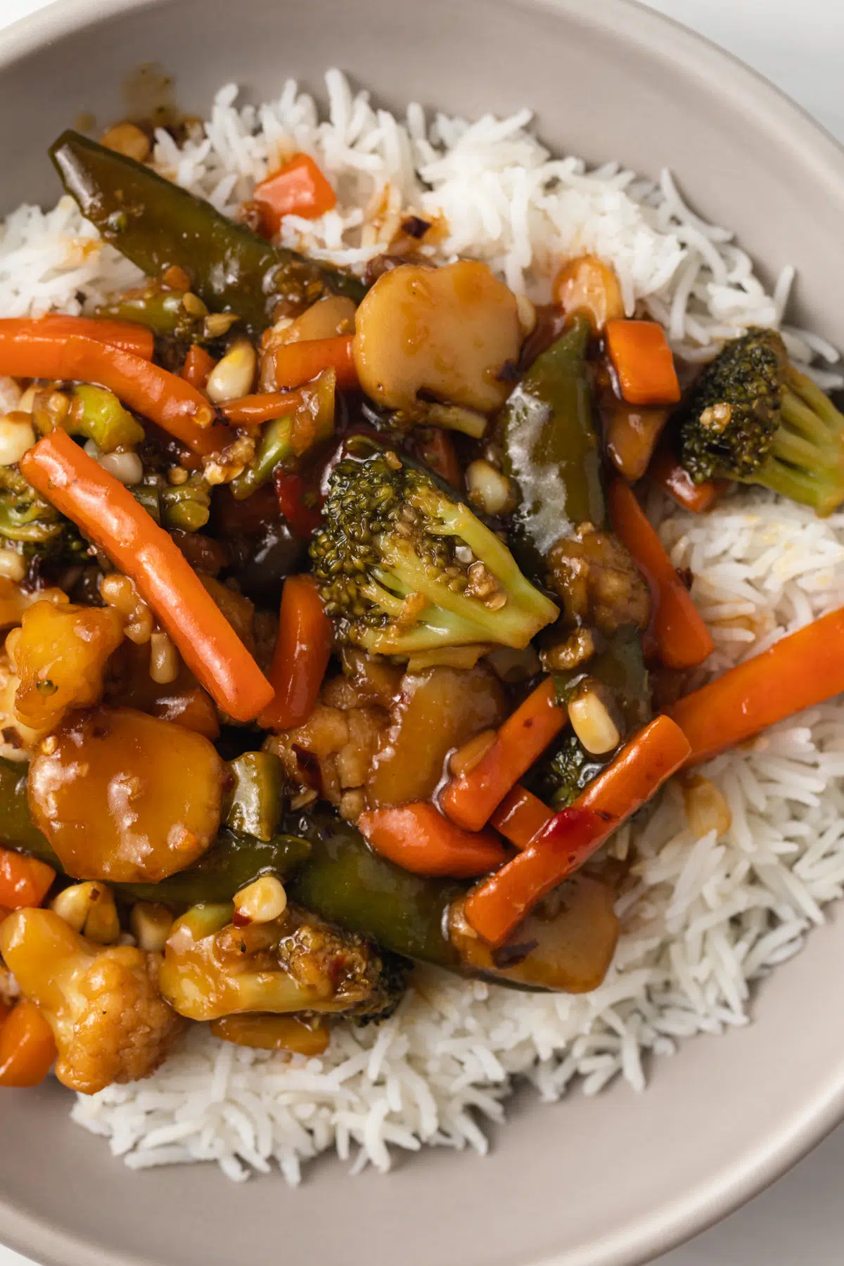 Vegetables and rice with stir fry sauce.