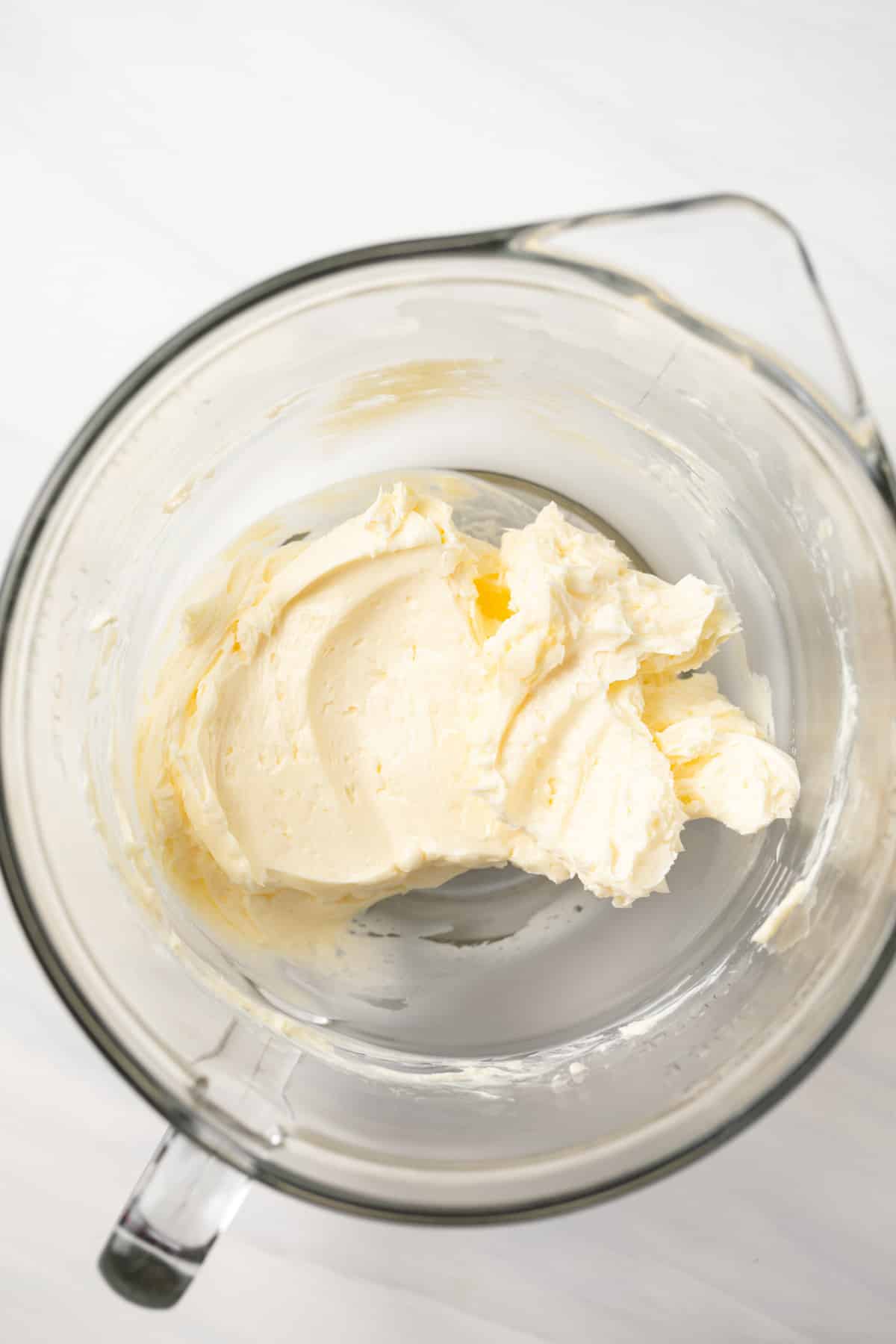 Creamed butter in a glass mixing bowl.