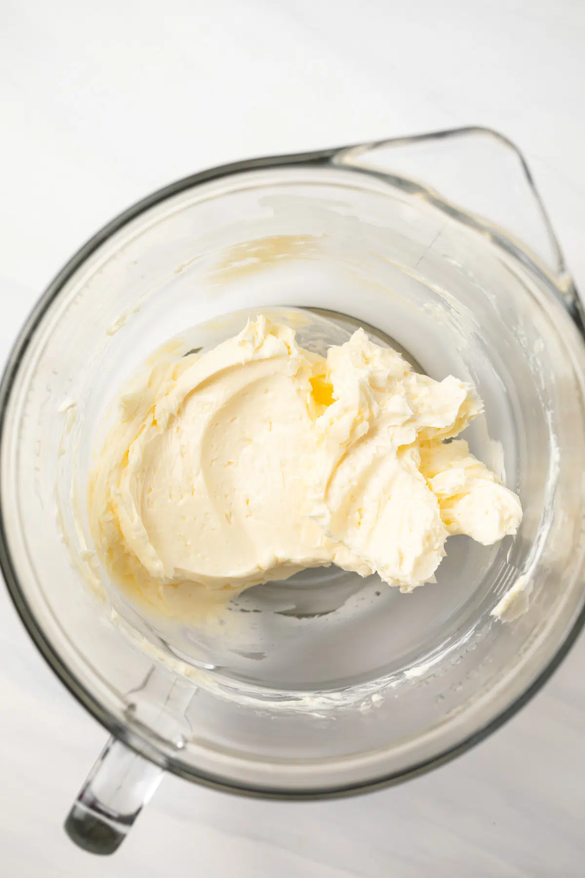 Creamed butter in a glass mixing bowl.