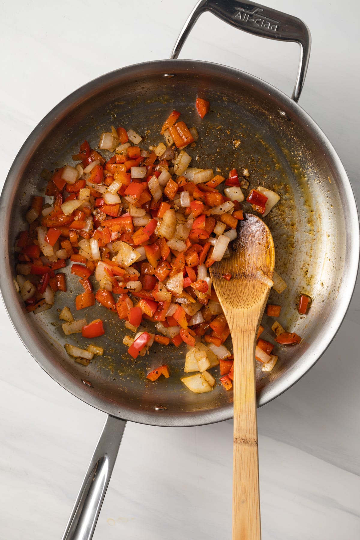 Seasoned peppers and onions in large fry pan.