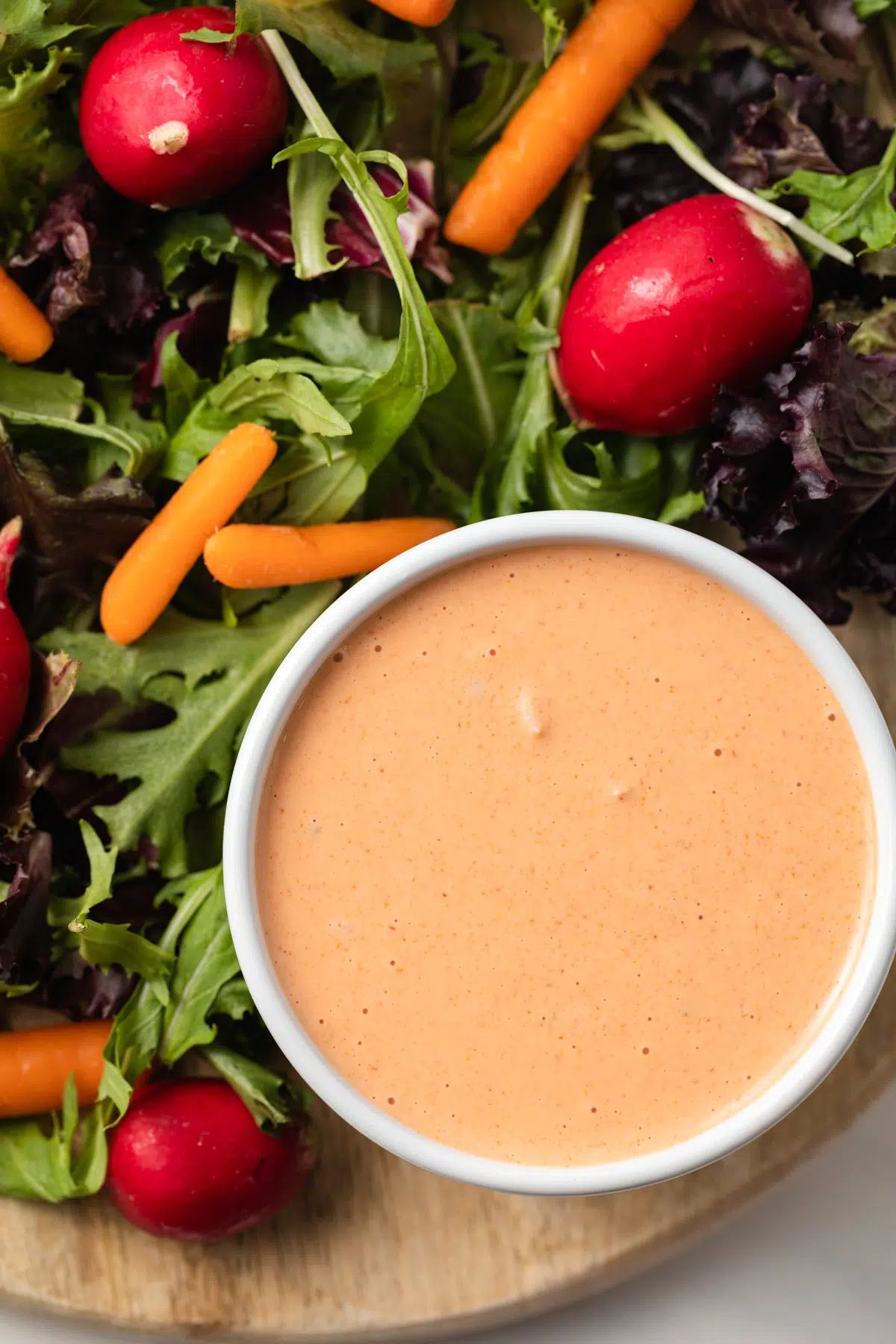 Overhead view of creamy russian dressing in white bowl.
