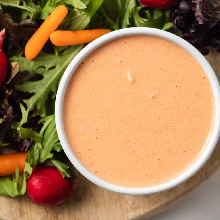Overhead view of creamy russian dressing in white bowl.