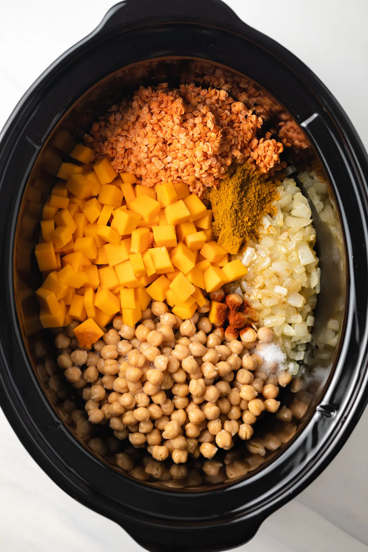 Ingredients for vegan pumpkin curry in a slow cooker.