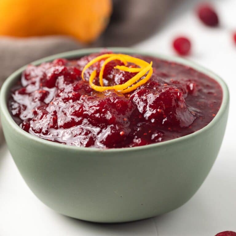 Side view of cranberry sauce in a green bowl.