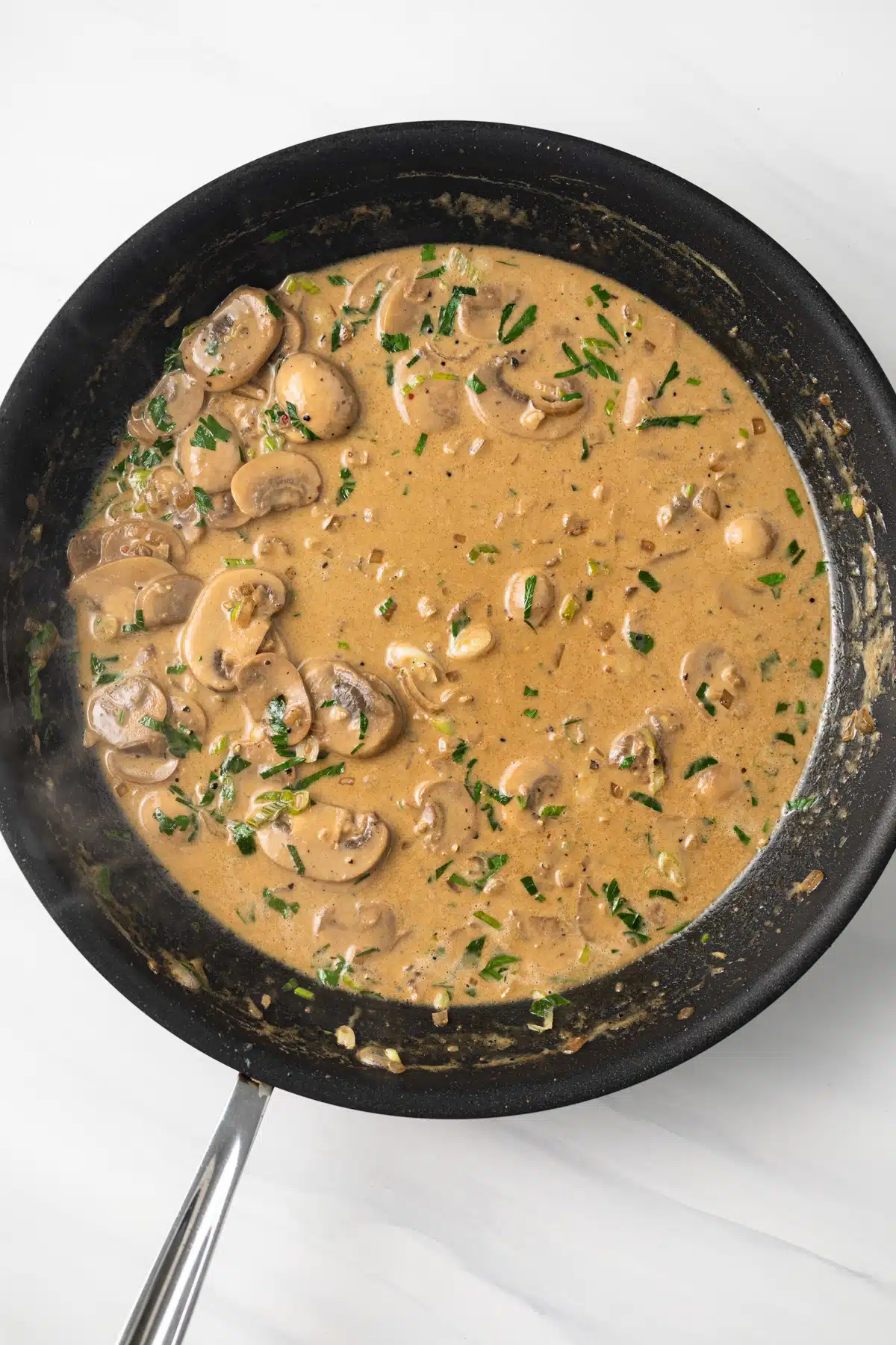 Diane sauce in a skillet.