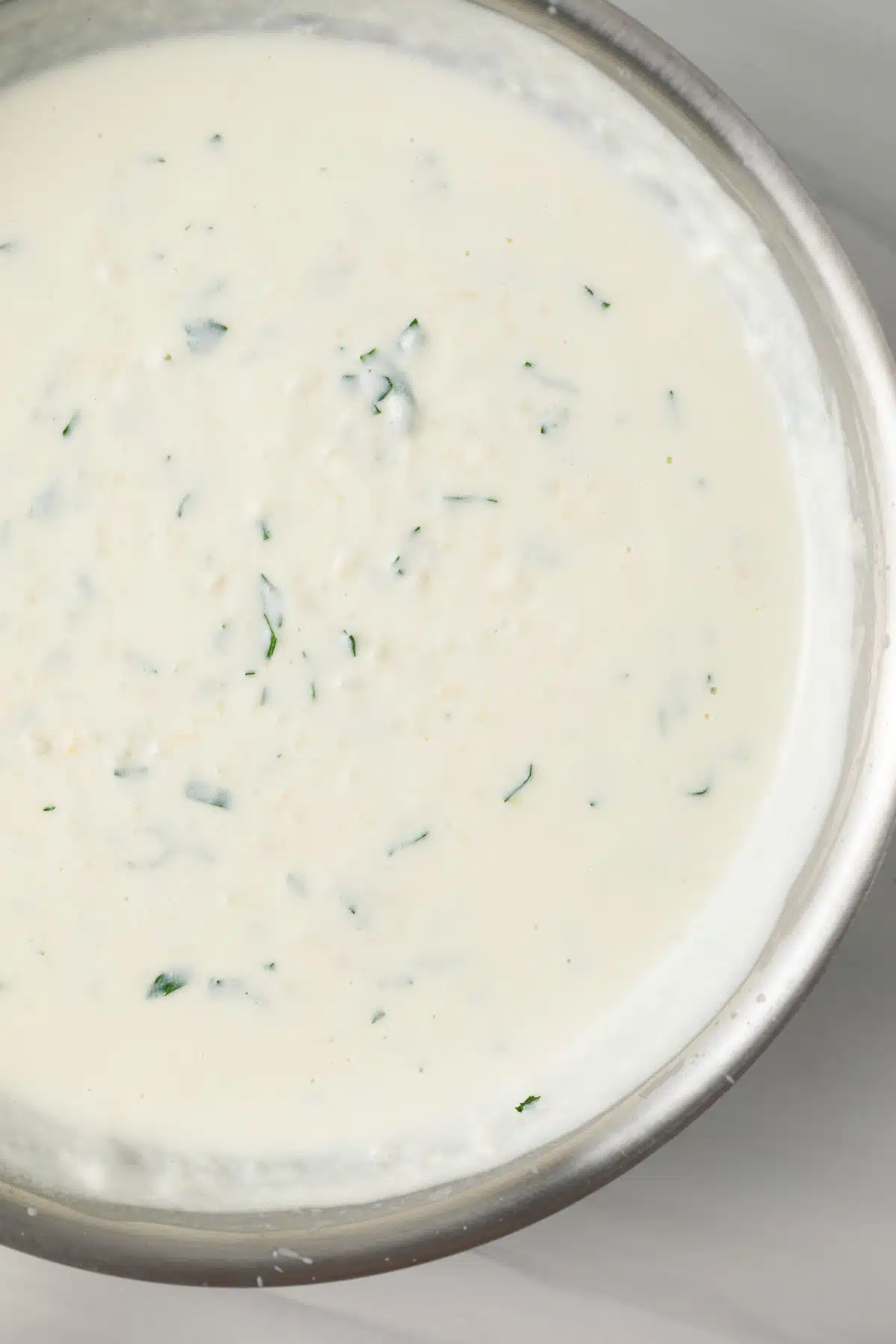 Close up of garlic cream sauce in skillet.