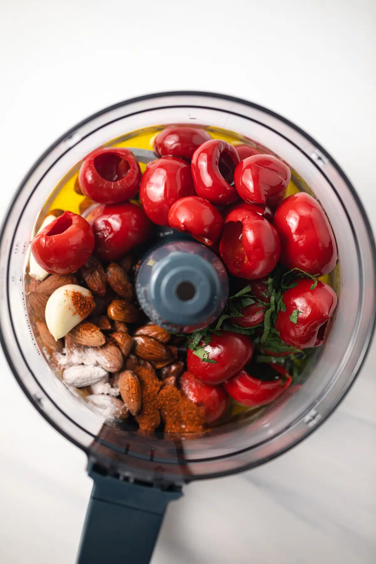 Ingredients for red pepper romesco in food processor.