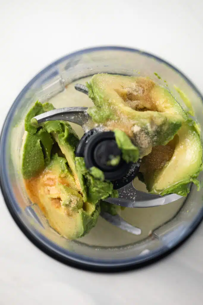 Avocado with spices in a food processor.