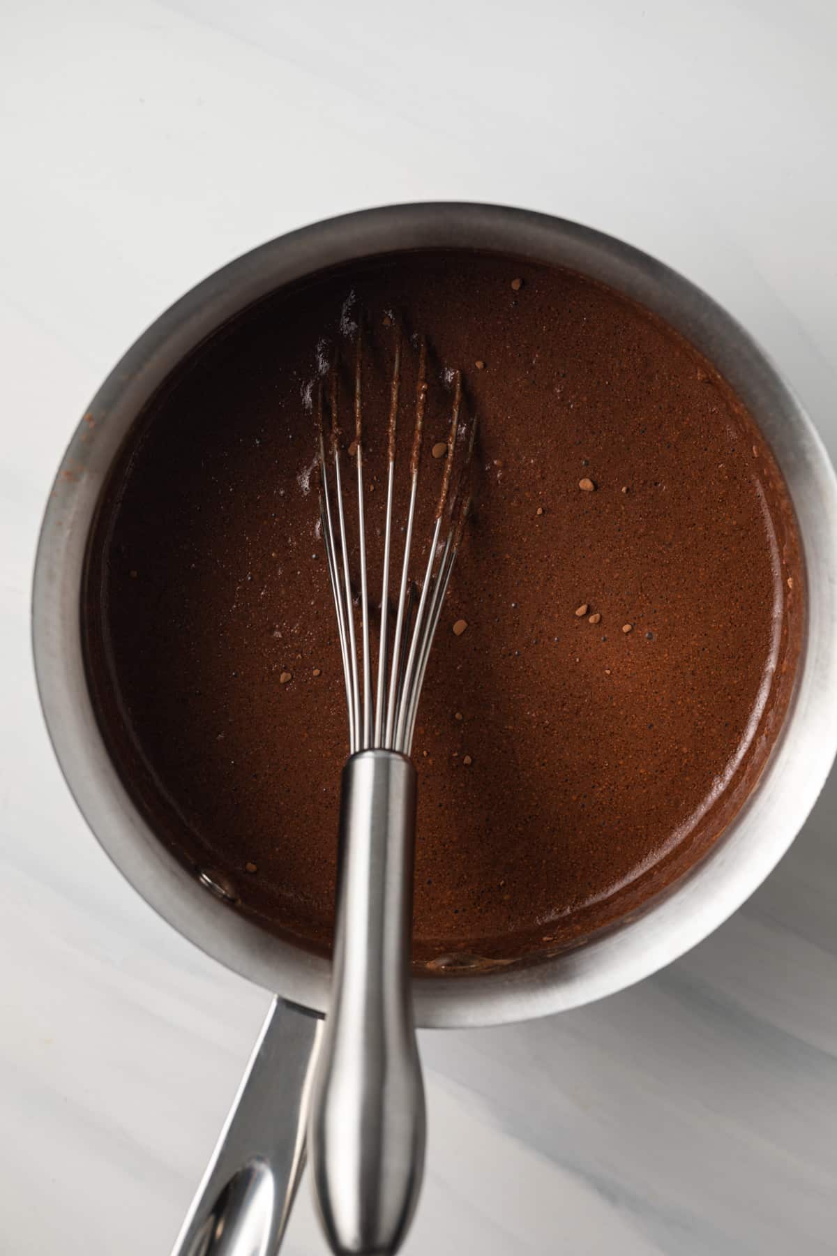 Uncooked chocolate sauce in saucepan.