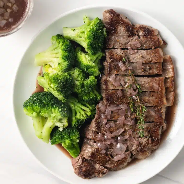 Red wine sauce over steak with broccoli.