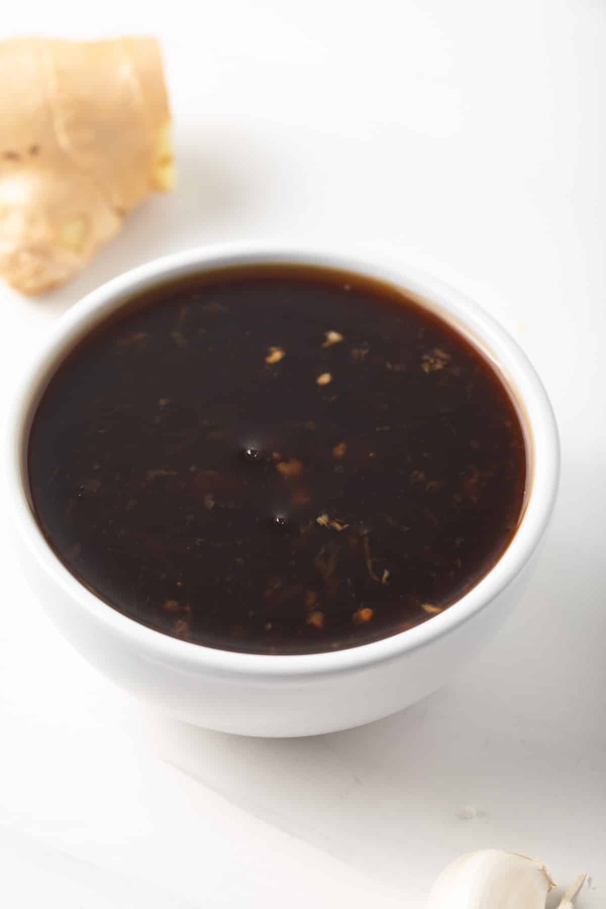 Teriyaki sauce in a white bowl.