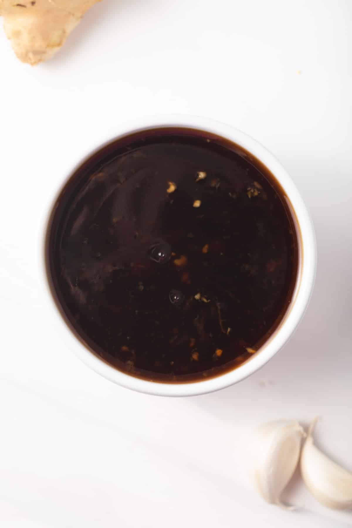 Overhead of teriyaki sauce in a white bowl.