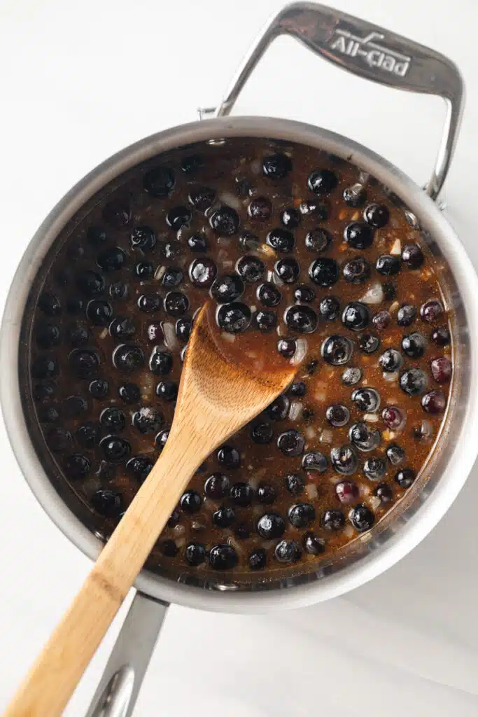 Blueberry BBQ sauce cooking in a saucepan.
