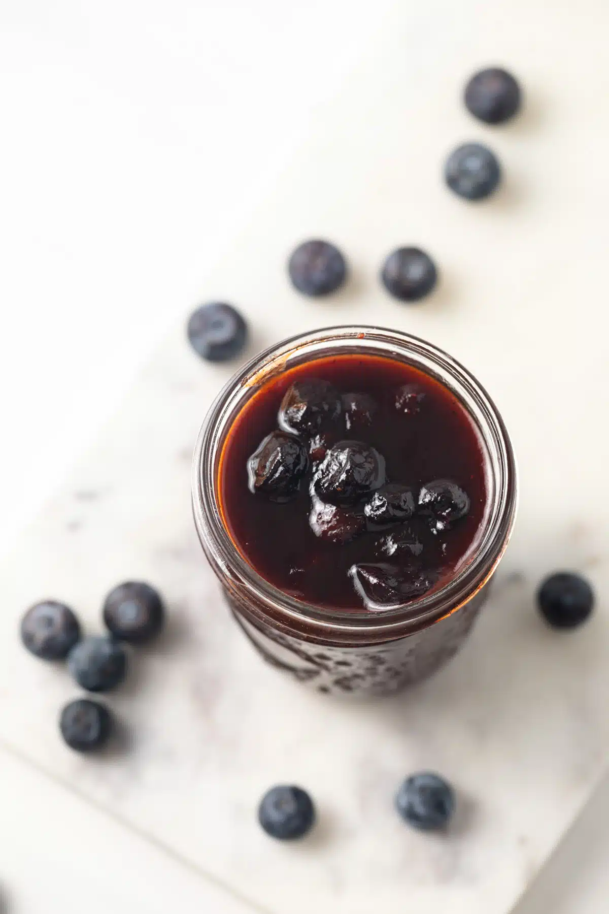 Overhead of blueberry BBQ sauce in a jar.