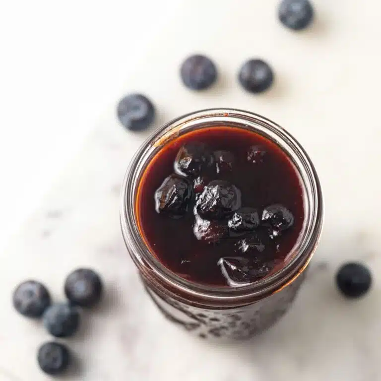 Overhead of blueberry BBQ sauce in a jar.