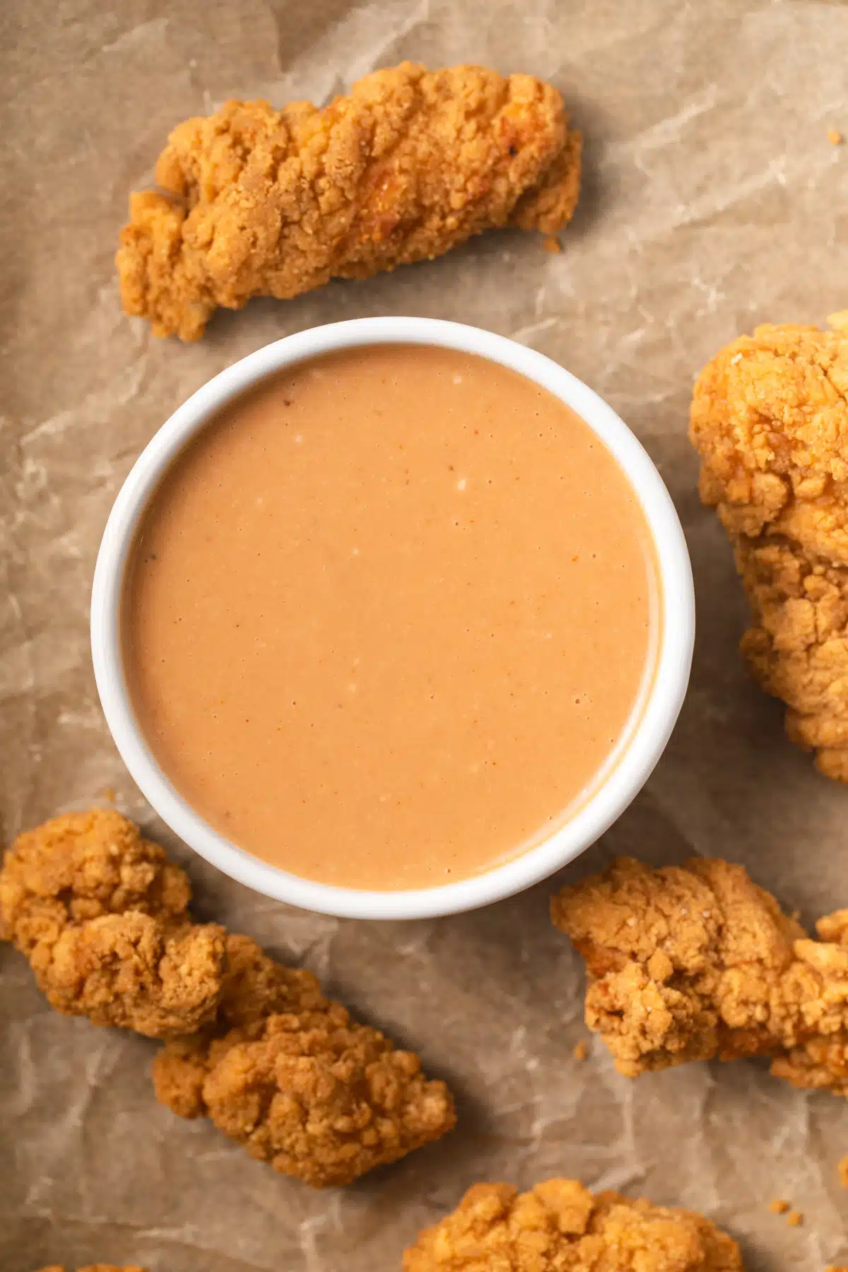 Chicken nugget dipping sauce in white bowl.