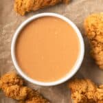 Chicken nugget dipping sauce in white bowl.