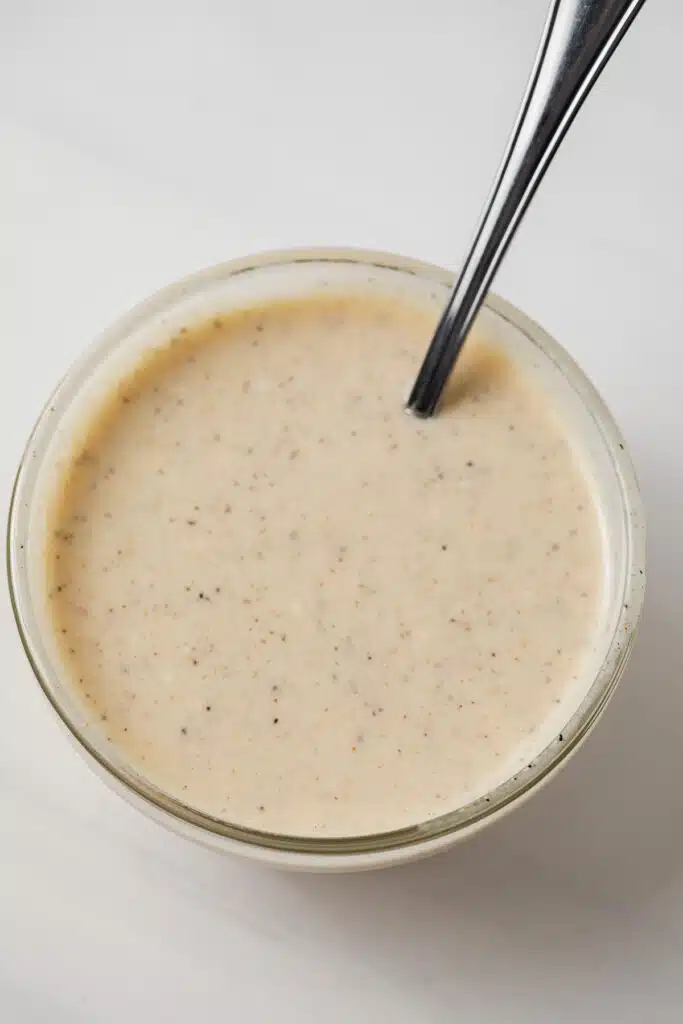 Coleslaw dressing in glass bowl.