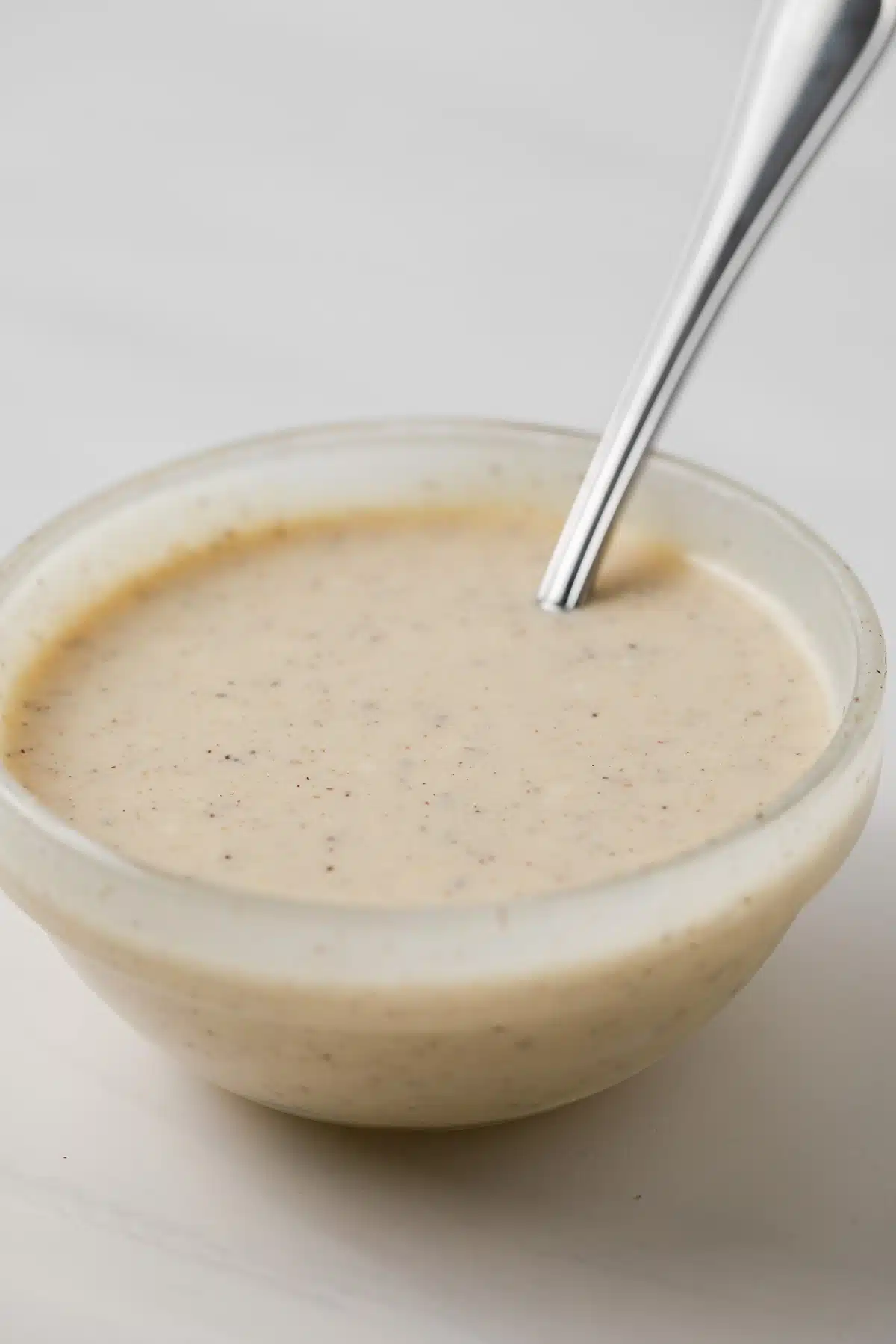 Coleslaw dressing in glass bowl.