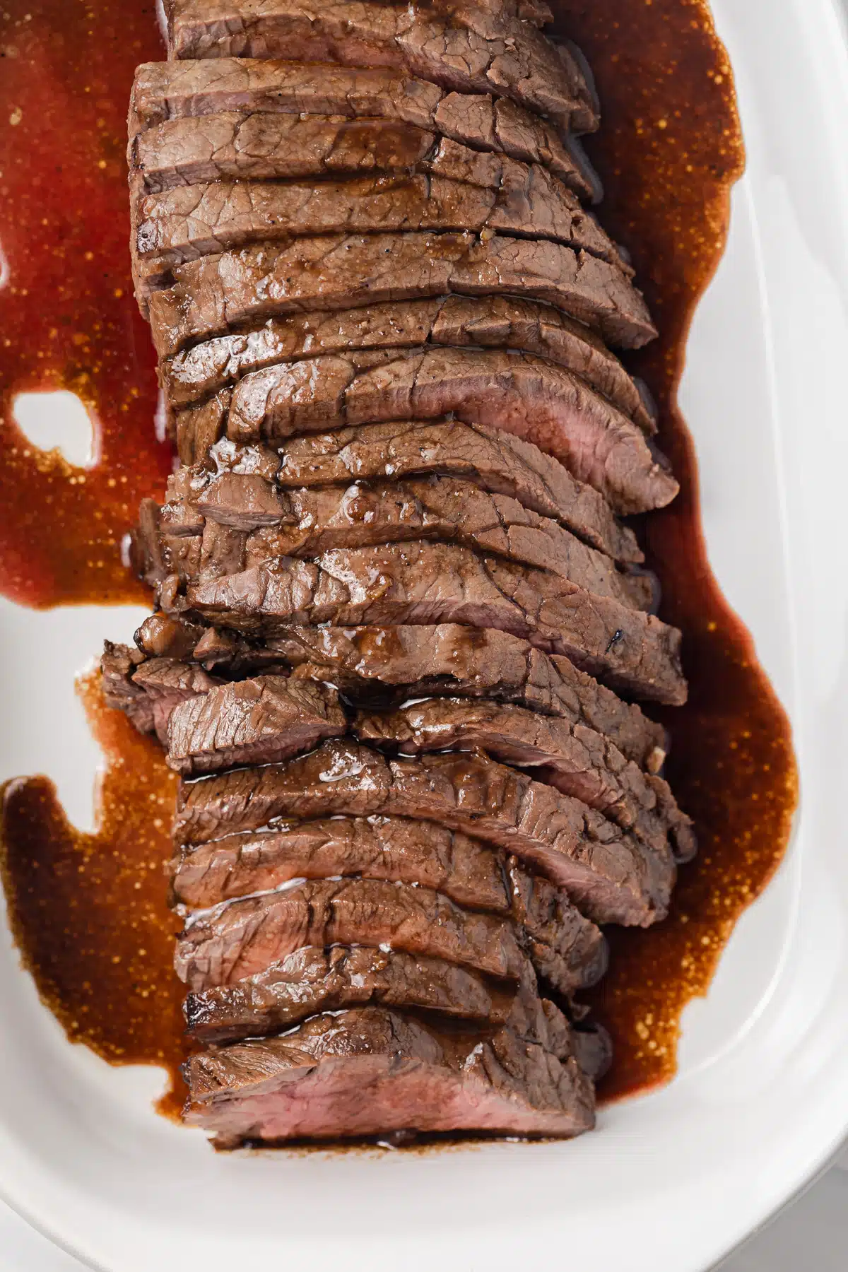 Marinated london broil in a baking dish.