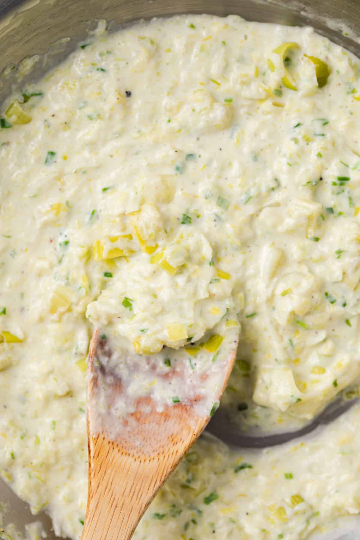 Close up of creamy leek sauce in skillet.