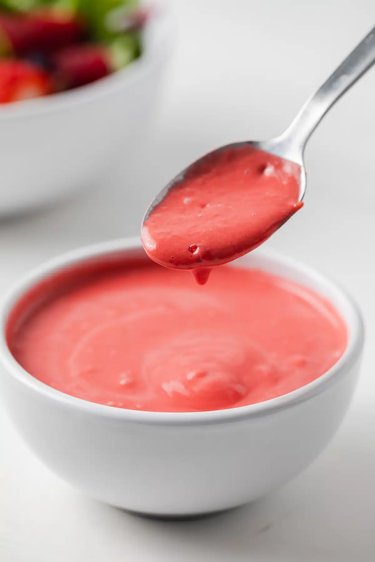 Raspberry vinaigrette on a spoon.