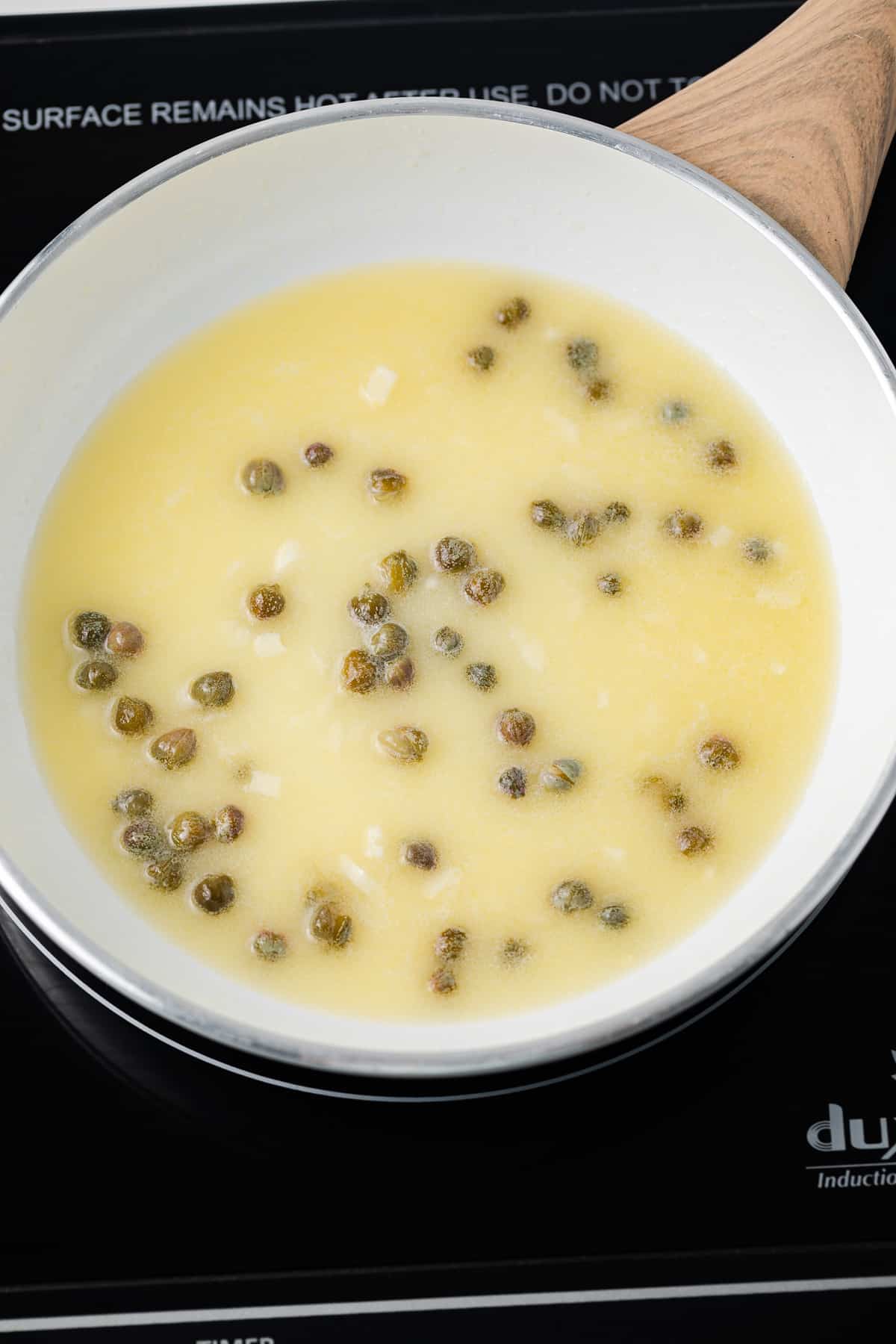 Butter, lemon juice, garlic, capers in skillet.