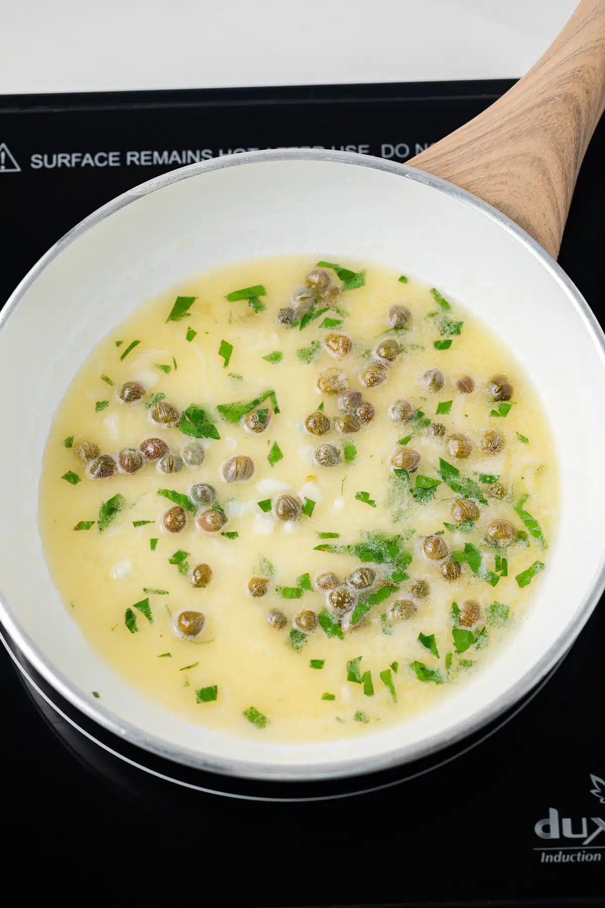 Lemon caper sauce in skillet.