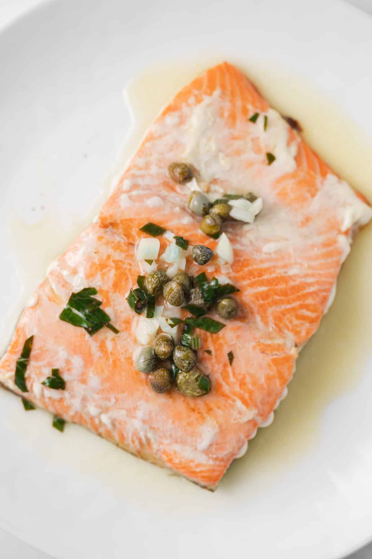 Salmon topped with lemon caper sauce.