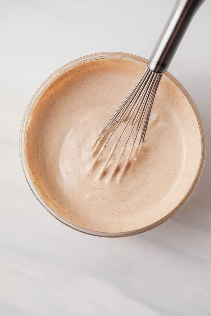 Quesadilla sauce in a glass bowl with whisk.