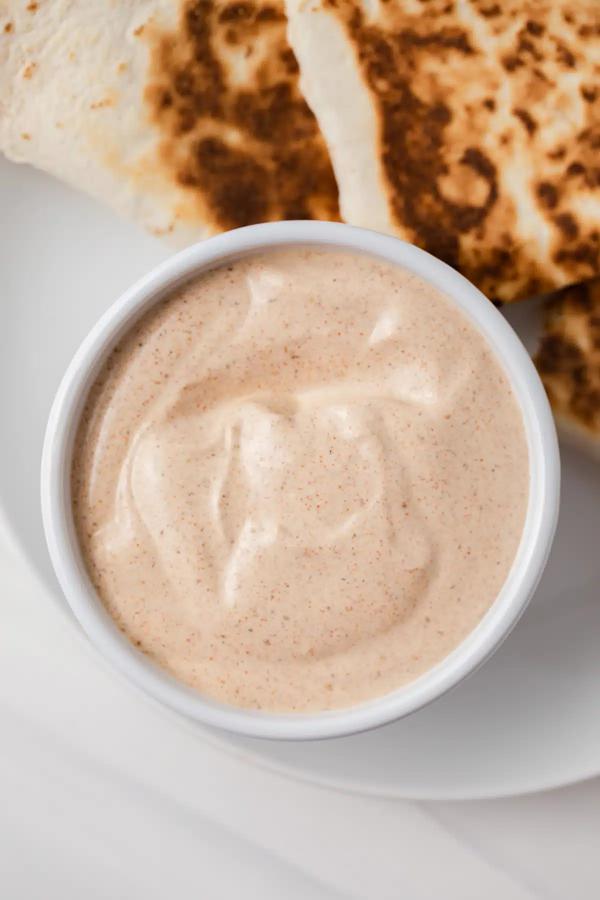 Close up of quesadilla sauce in white bowl.