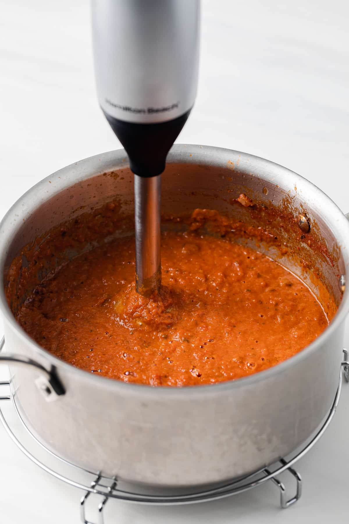 Immersion blender pureeing ranchero sauce.