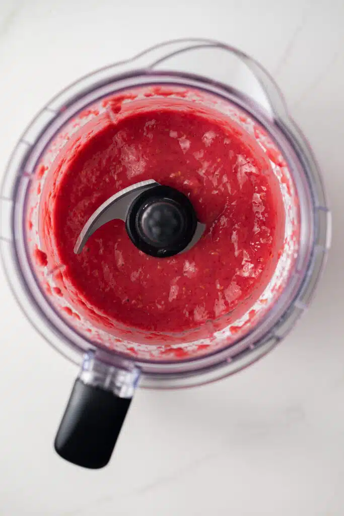 Pureed raspberries in a blender.