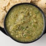 Close up of salsa verde in black bowl.