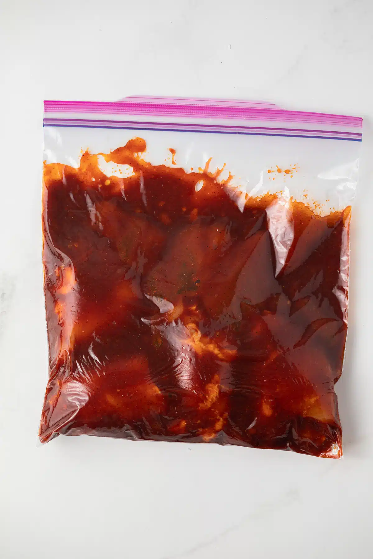 Chicken in zip top bag with spicy marinade.