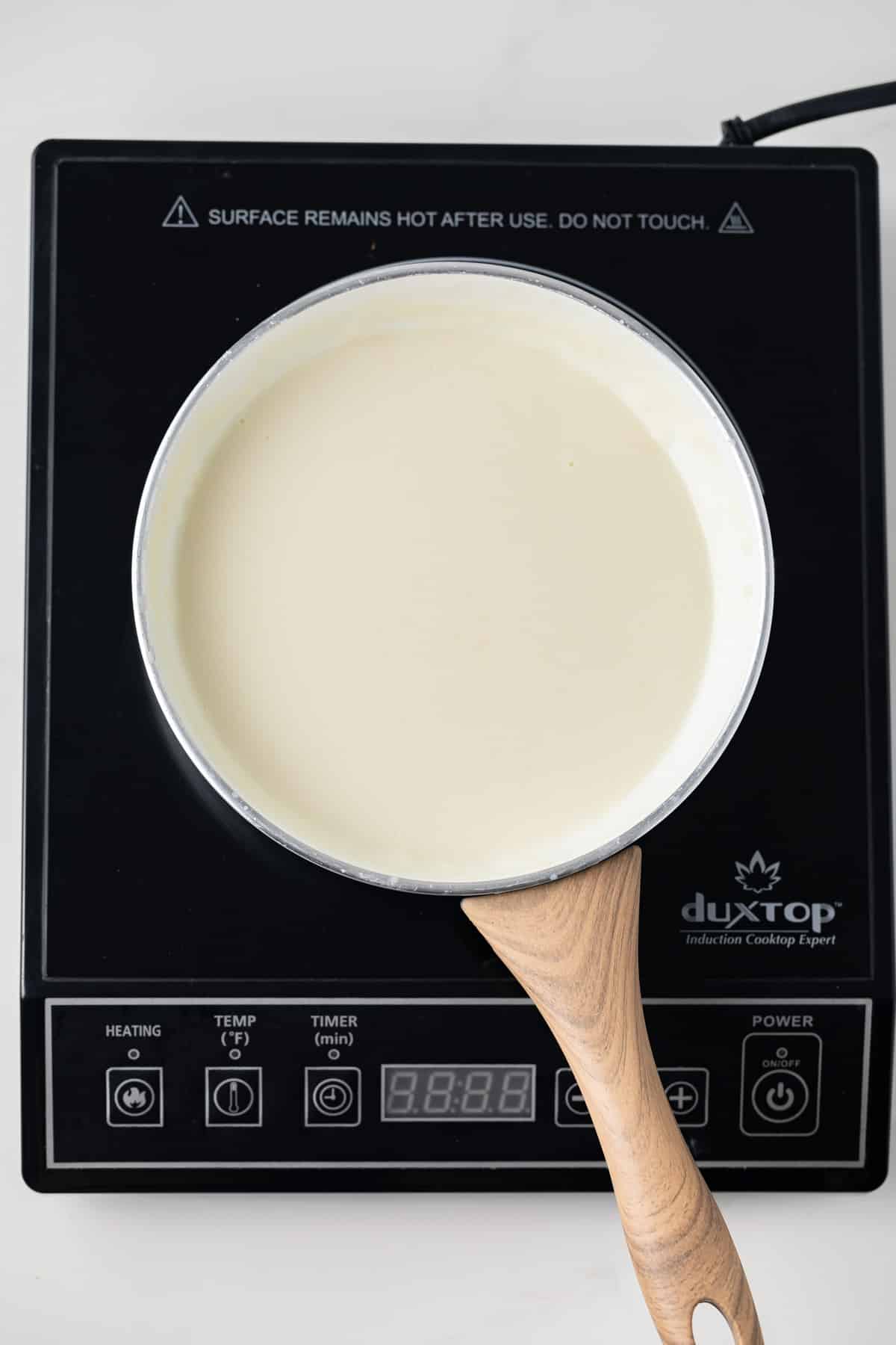 Basic White Sauce (Béchamel) in a white skillet.