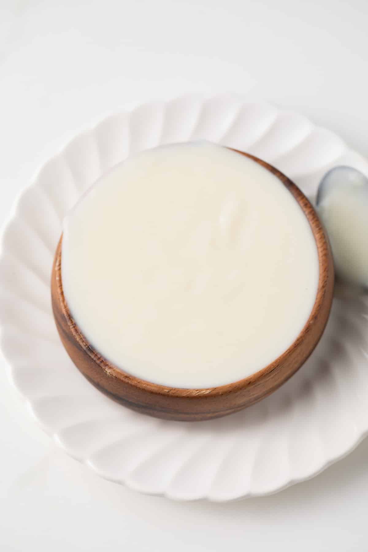 Basic White Sauce (Béchamel) in a brown bowl.