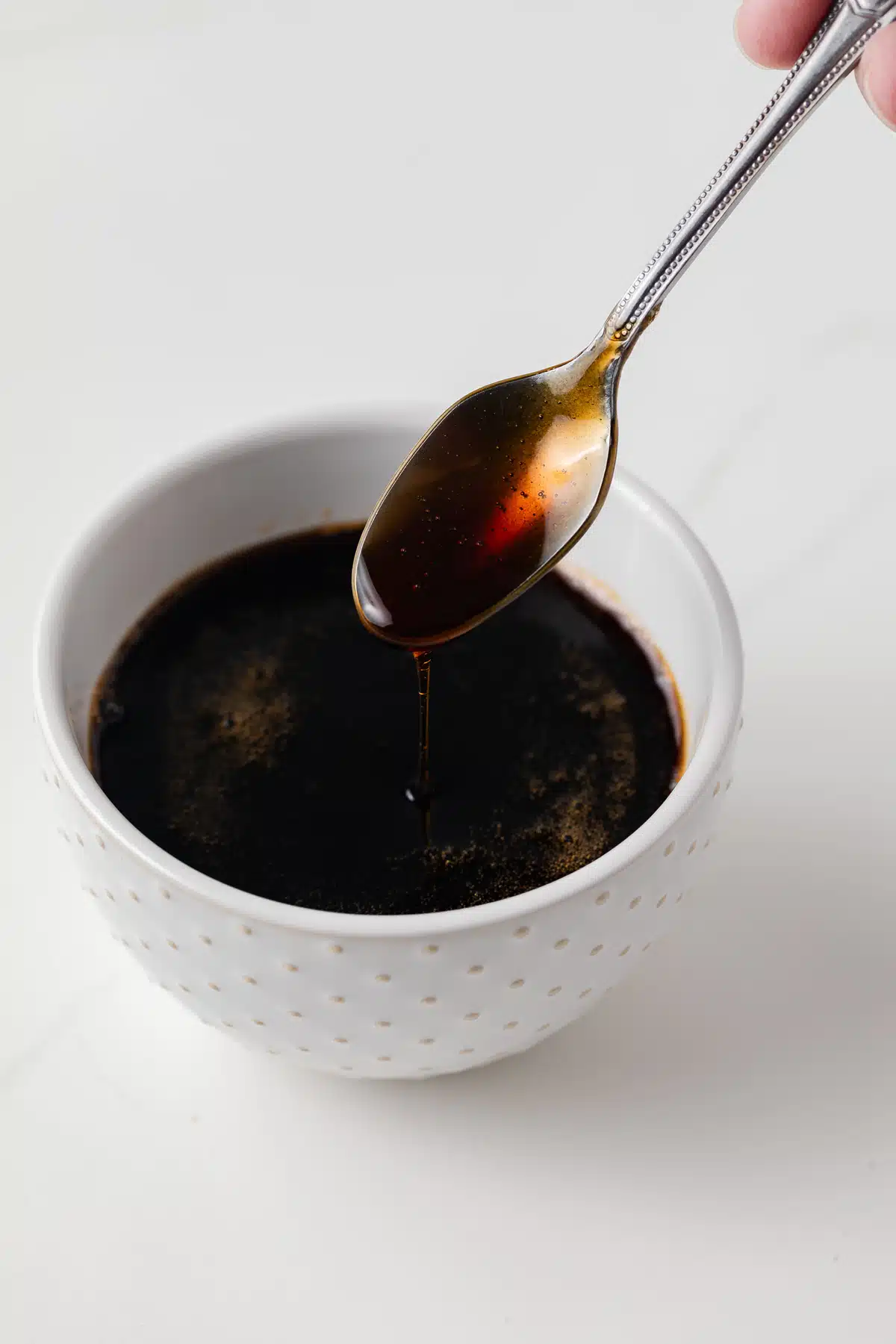 Spoon dripping with eel sauce.
