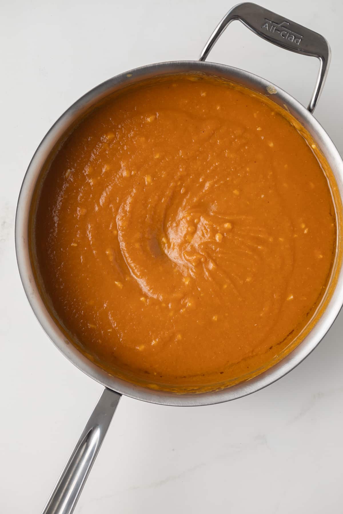 Creamy pumpkin puree in a skillet.