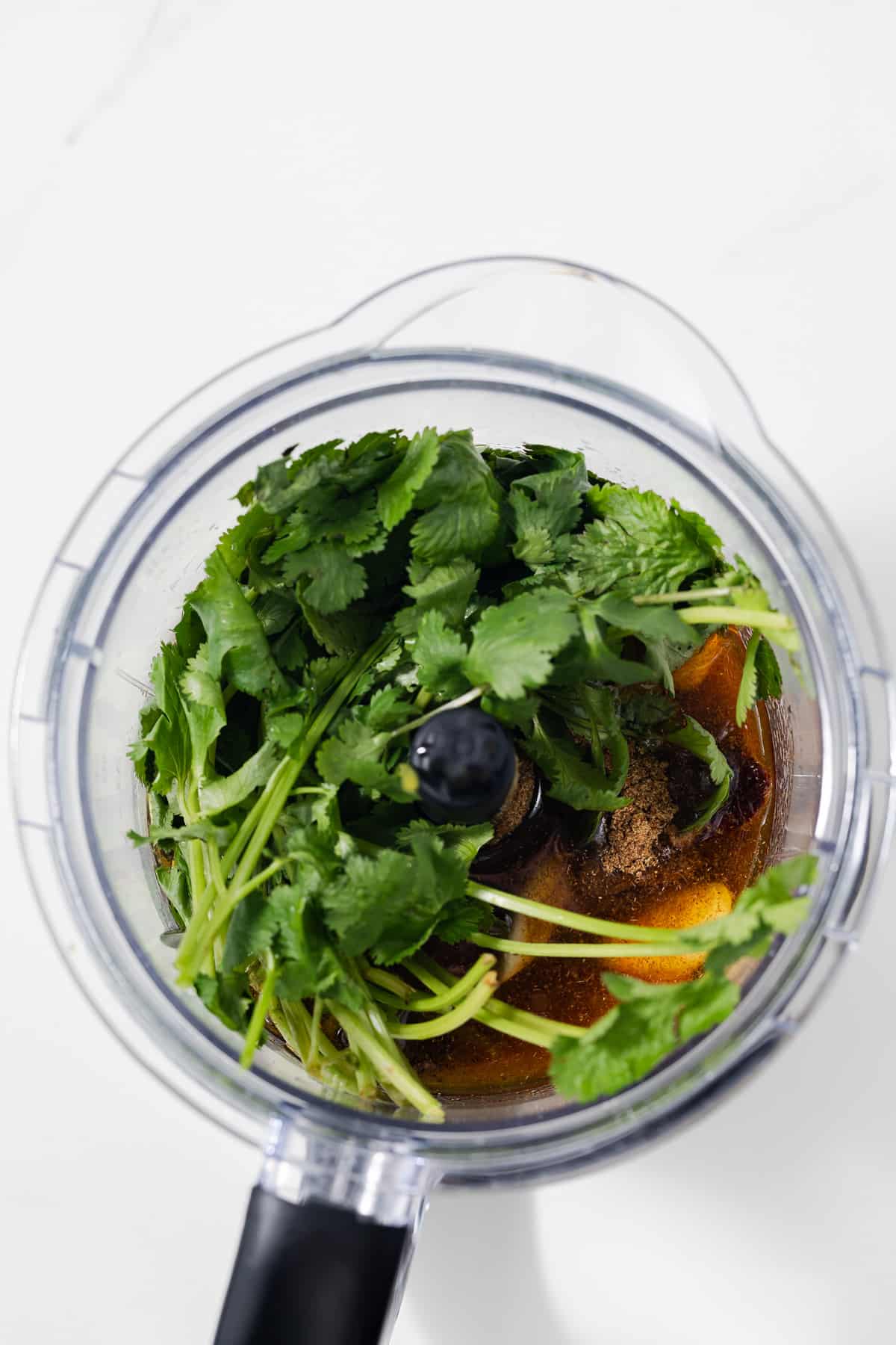 Ingredients for carne asada marinade in a food processor.